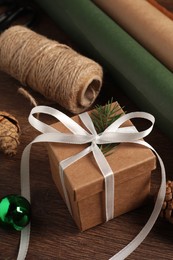 Beautiful gift box and Christmas decorations on wooden table