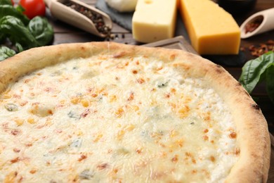 Delicious cheese pizza and ingredients on table, closeup