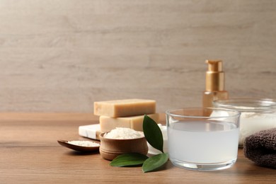 Homemade natural rice water and cosmetic products on wooden table. Space for text