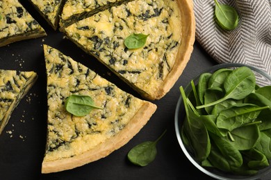 Cut delicious spinach pie on slate plate, flat lay