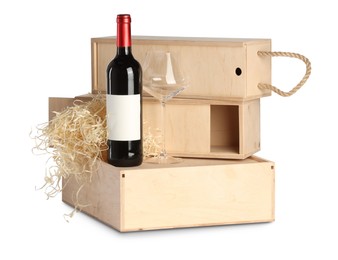 Photo of Wooden gift boxes with wine and glass isolated on white