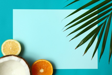 Photo of Flat lay composition with fresh coconut half on blue background. Space for text