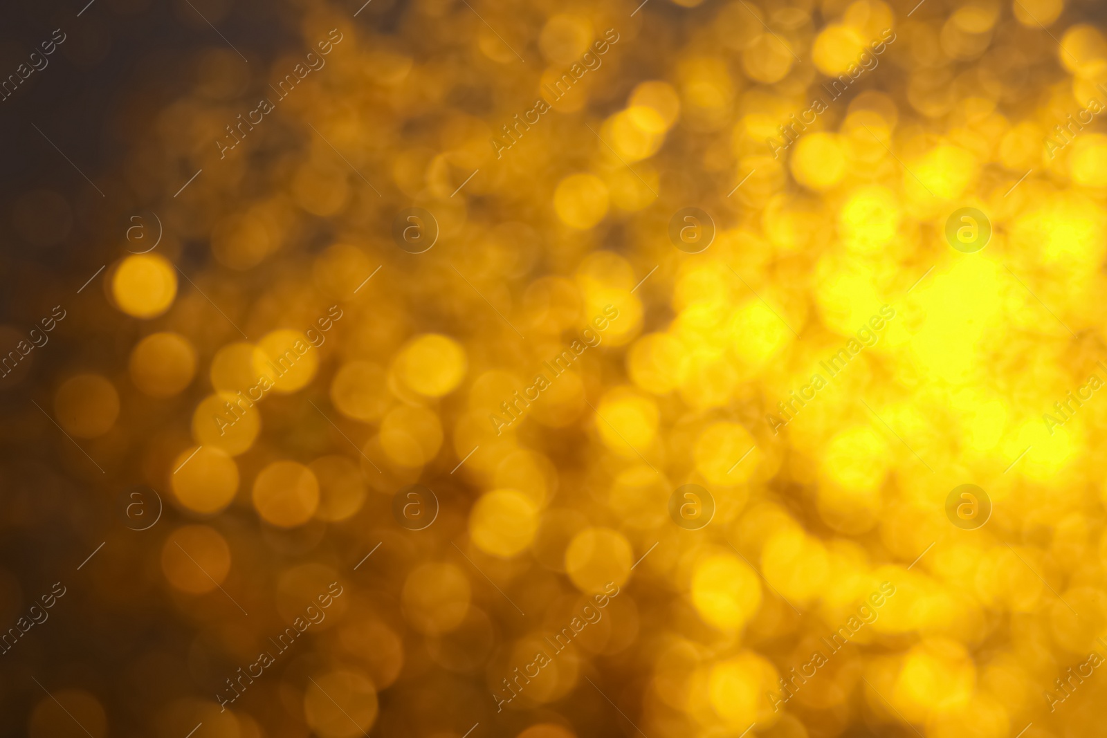 Photo of Blurred view of golden lights as background. Bokeh effect