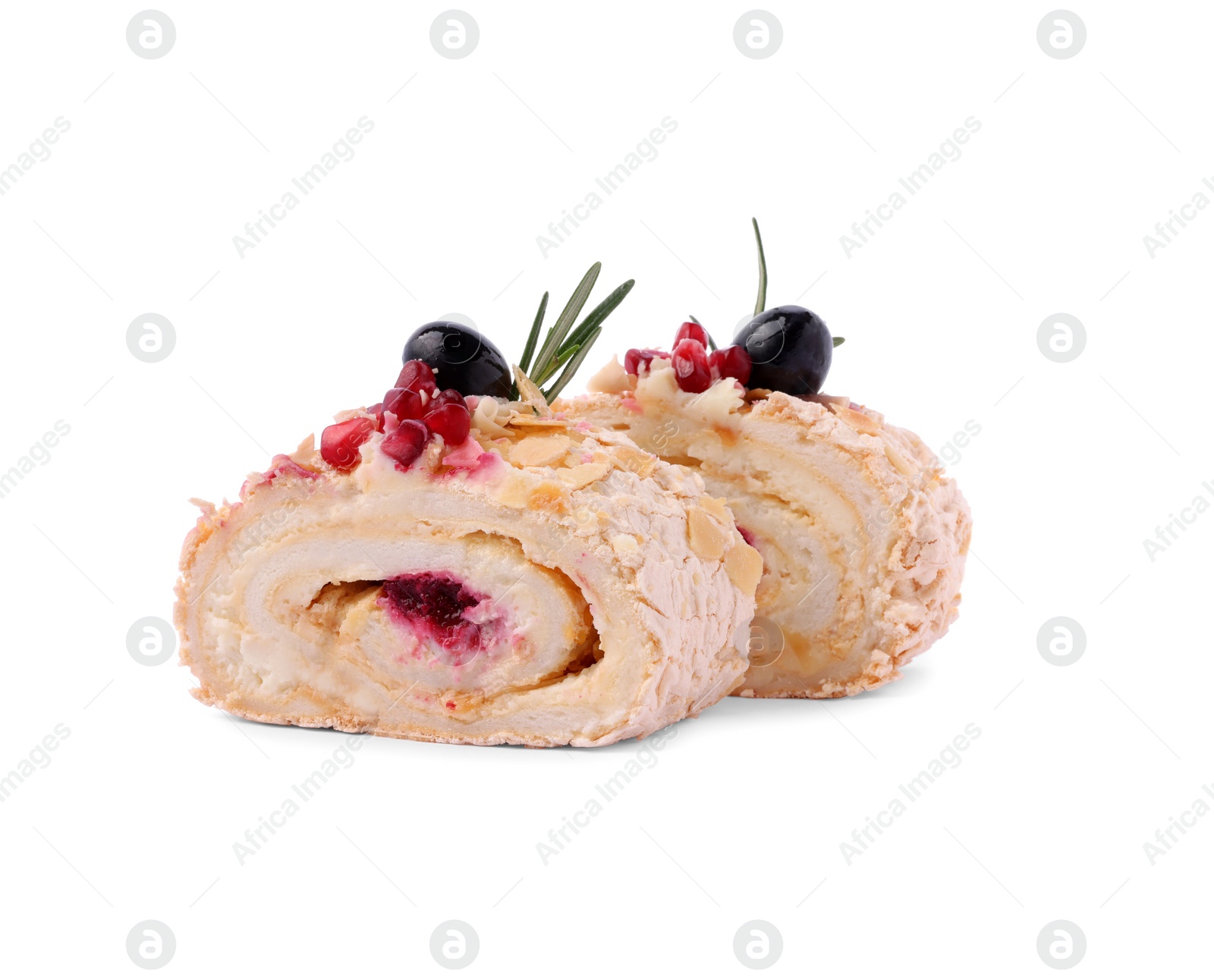Photo of Slices of tasty meringue roll with jam, pomegranate seeds and rosemary isolated on white