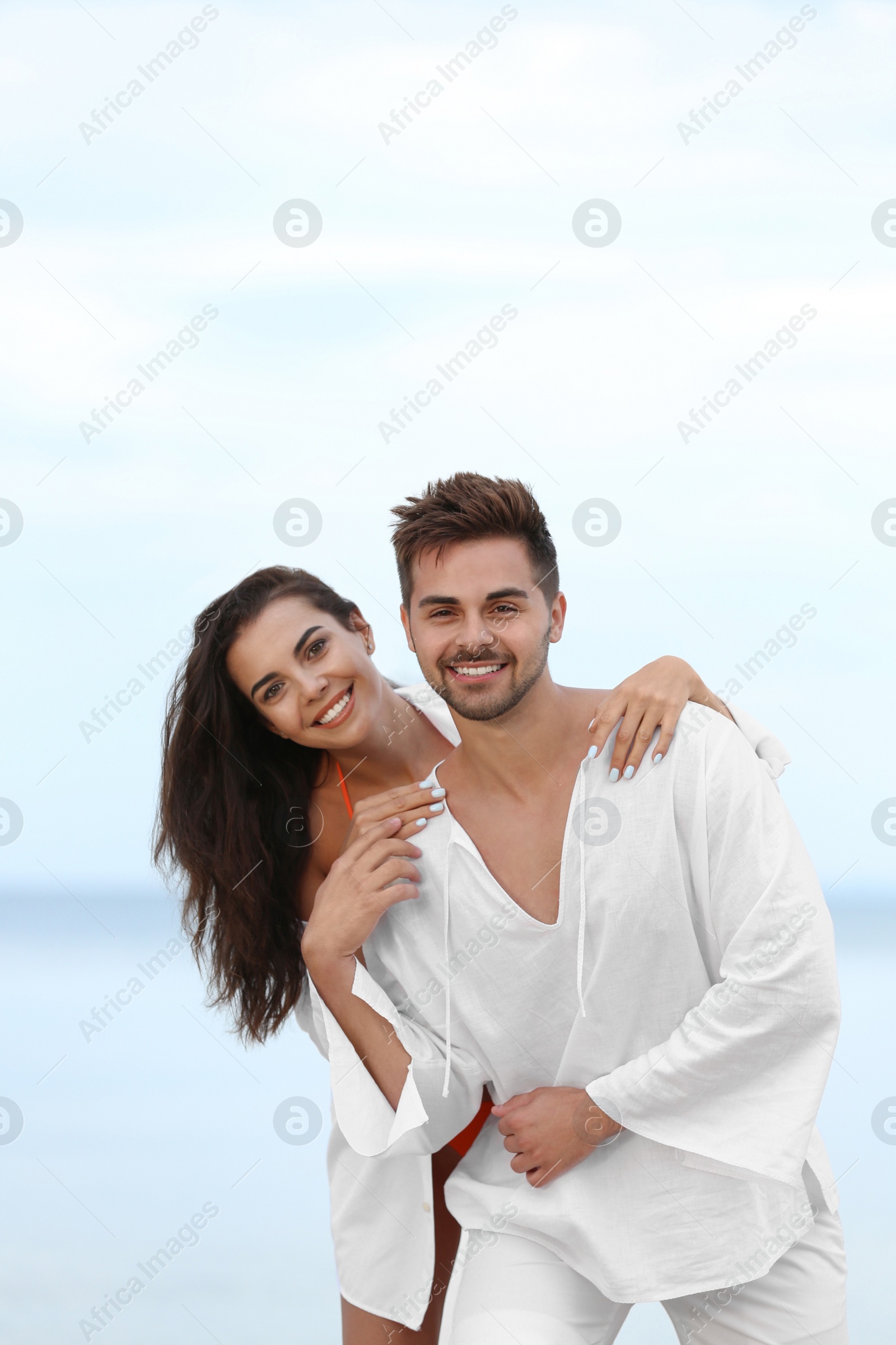 Photo of Happy young couple spending time together on beach