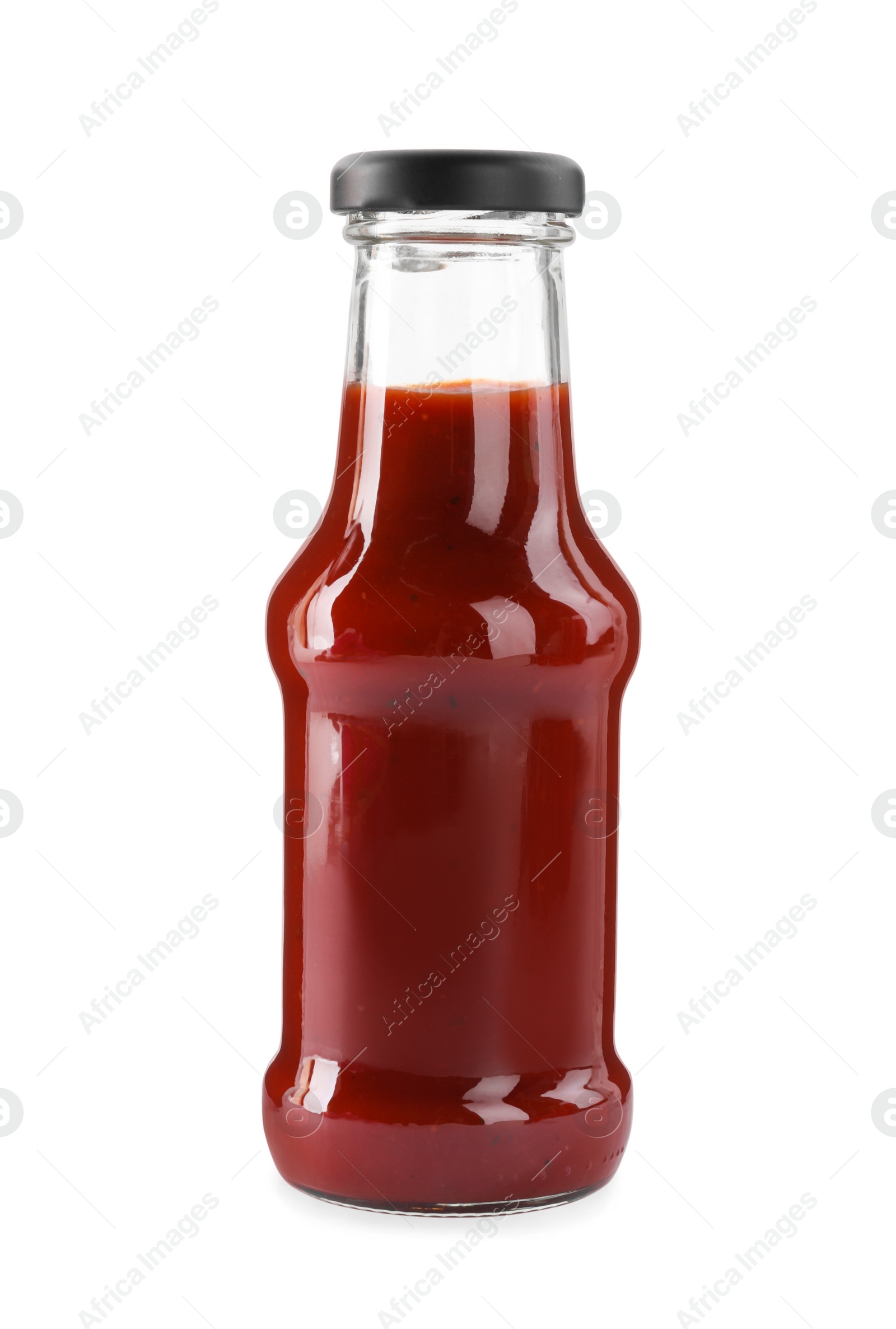 Photo of Glass bottle of tasty ketchup isolated on white