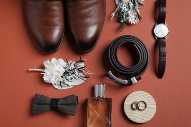 Wedding stuff. Flat lay composition with stylish boutonniere on brown background