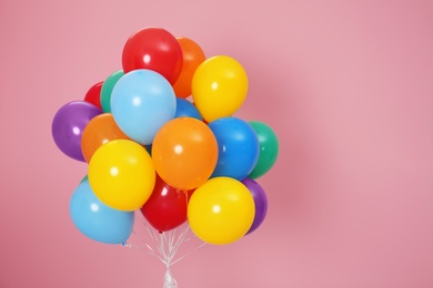 Photo of Bunch of bright balloons and space for text against color background