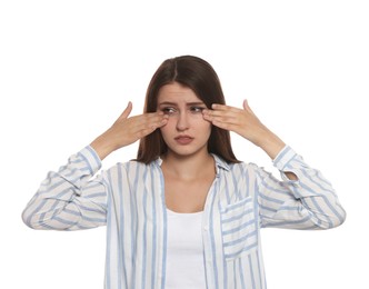 Photo of Young woman suffering from eyestrain on white background