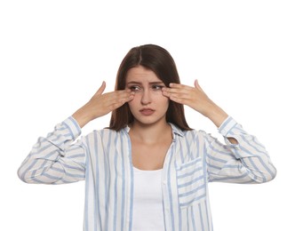 Young woman suffering from eyestrain on white background