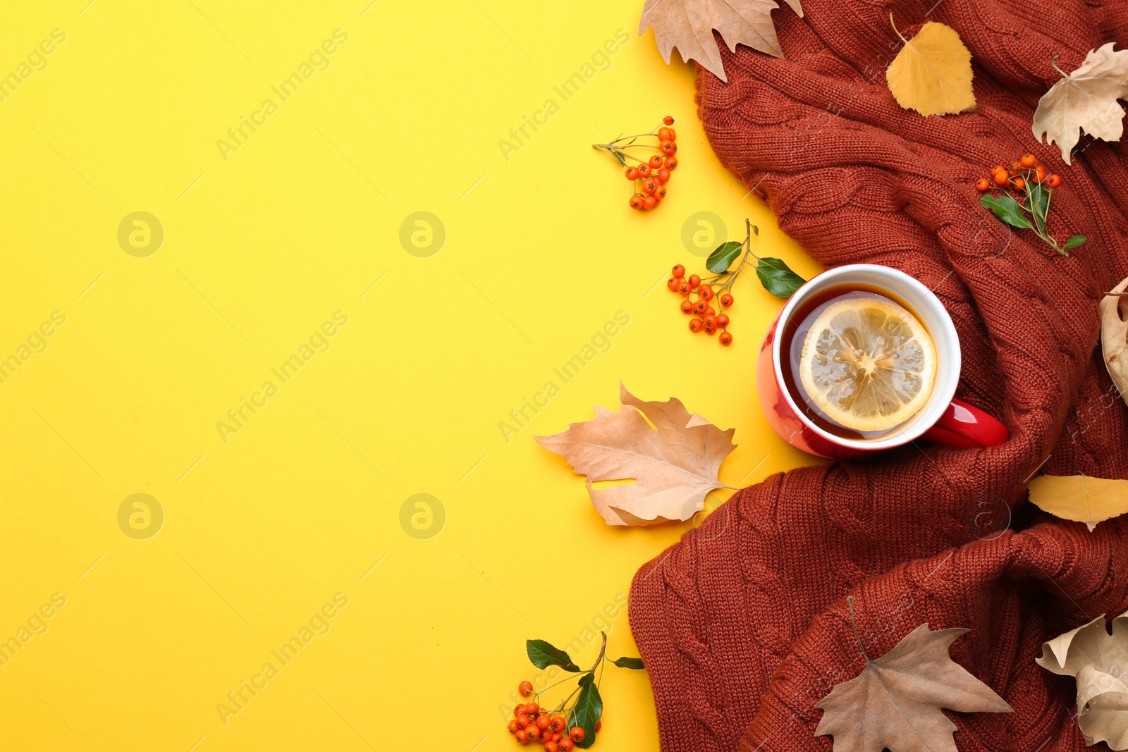 Photo of Flat lay composition with hot drink on yellow background, space for text. Cozy autumn