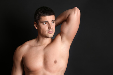 Photo of Man with sexy body on black background