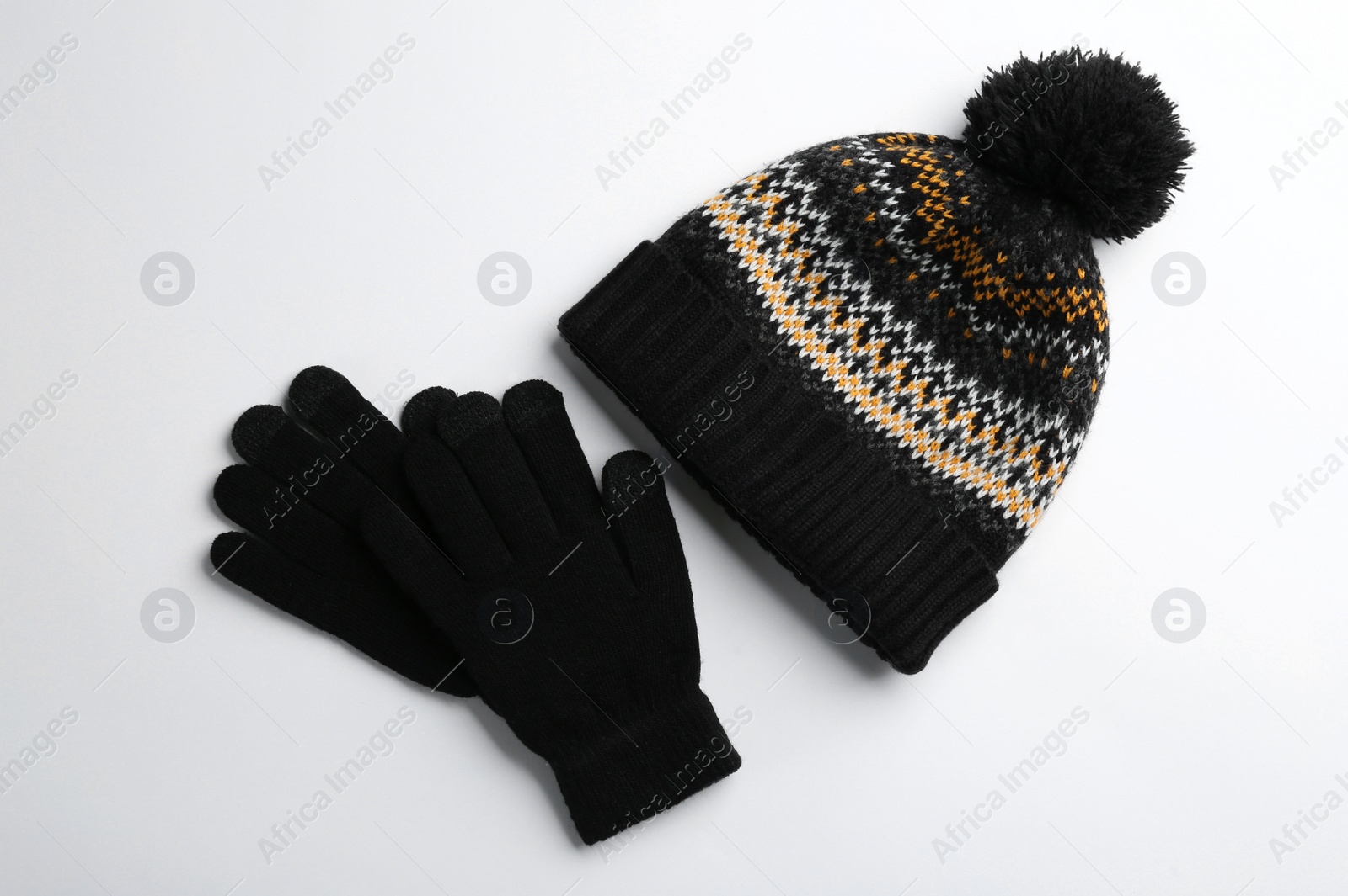 Photo of Woolen gloves and hat on white background, flat lay