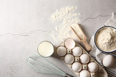 Photo of Making dough. Flour, eggs, milk and tools on light textured table, flat lay. Space for text