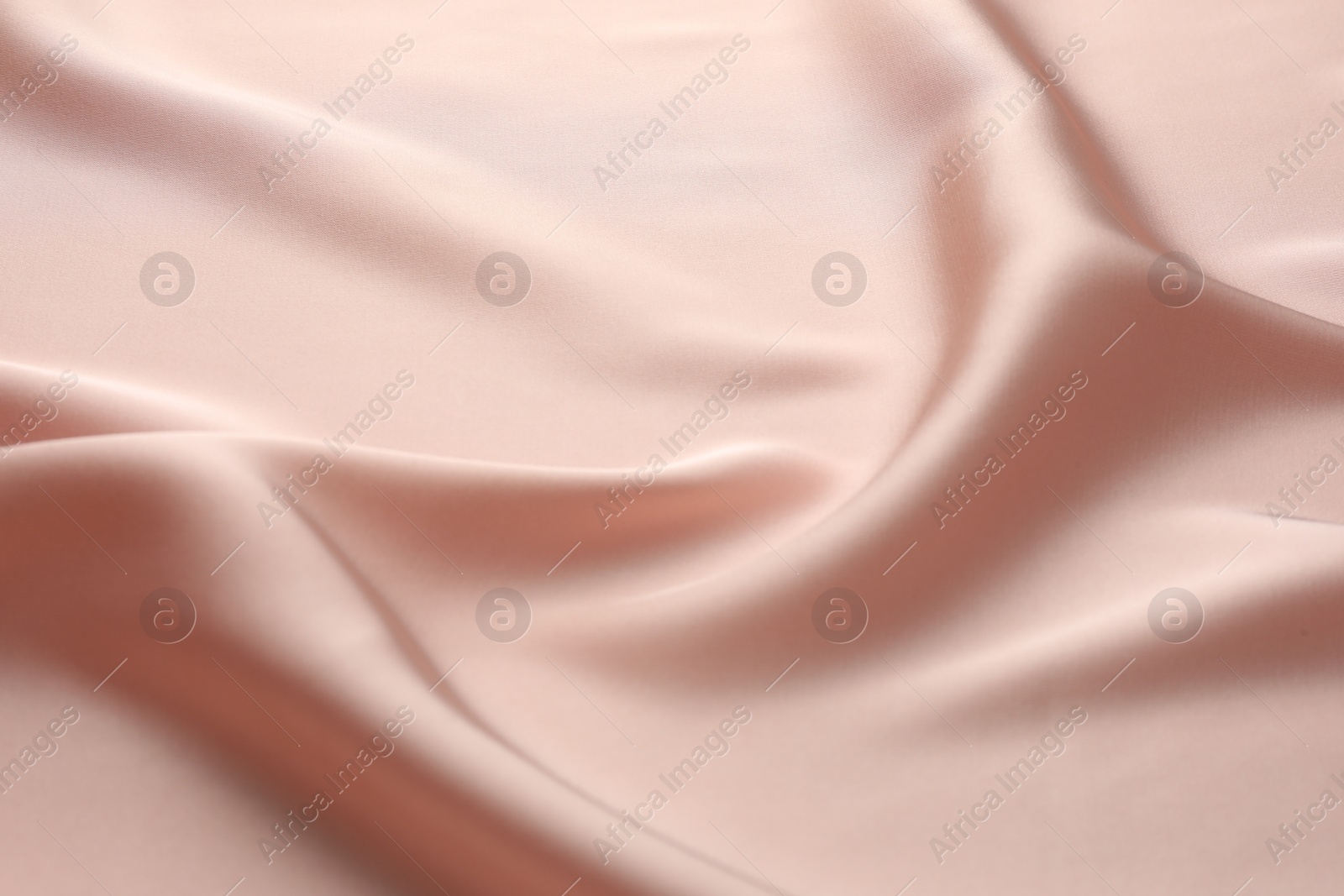 Photo of Crumpled pink silk fabric as background, closeup