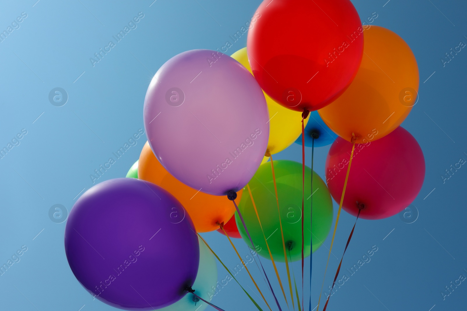 Photo of Bunch of colorful balloons against blue sky