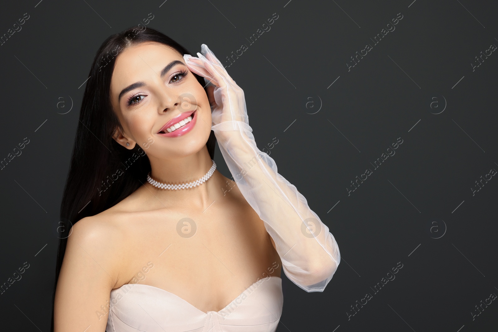 Photo of Portrait of young woman with beautiful makeup on black background. Space for text