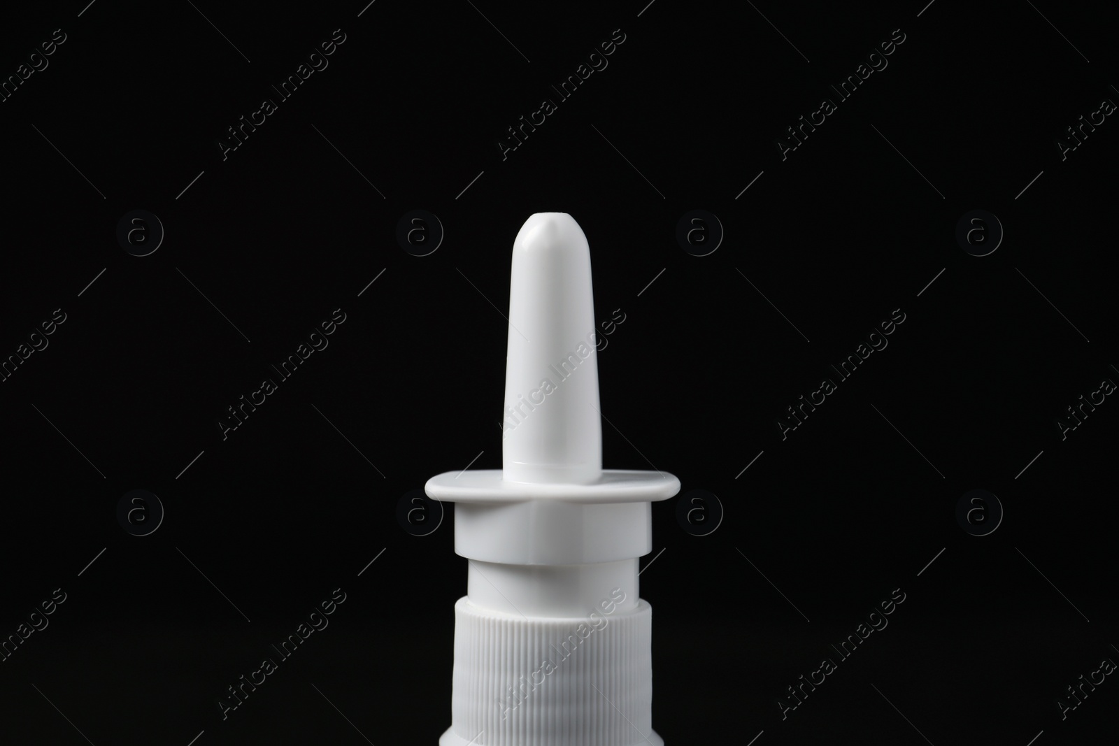 Photo of Bottle of nasal spray on black background, closeup