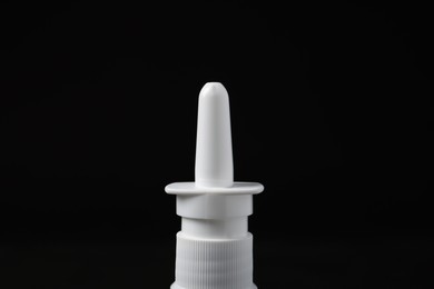 Photo of Bottle of nasal spray on black background, closeup