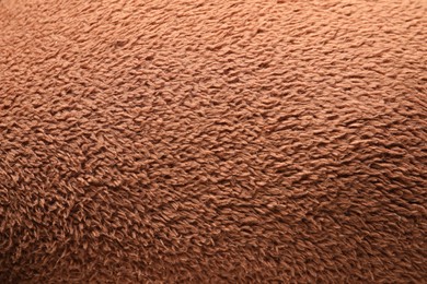 Photo of Texture of brown faux fur as background, top view