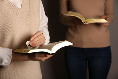 Photo of Women reading Bibles together, closeup. Religious literature