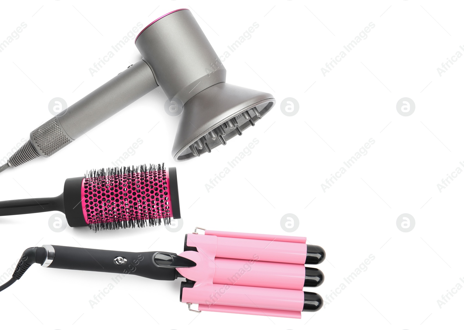 Image of Hair dryer, round brush and triple curling iron on white background, top view