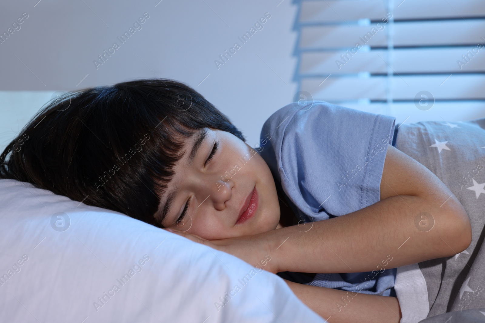 Photo of Cute little boy sleeping in bed at home