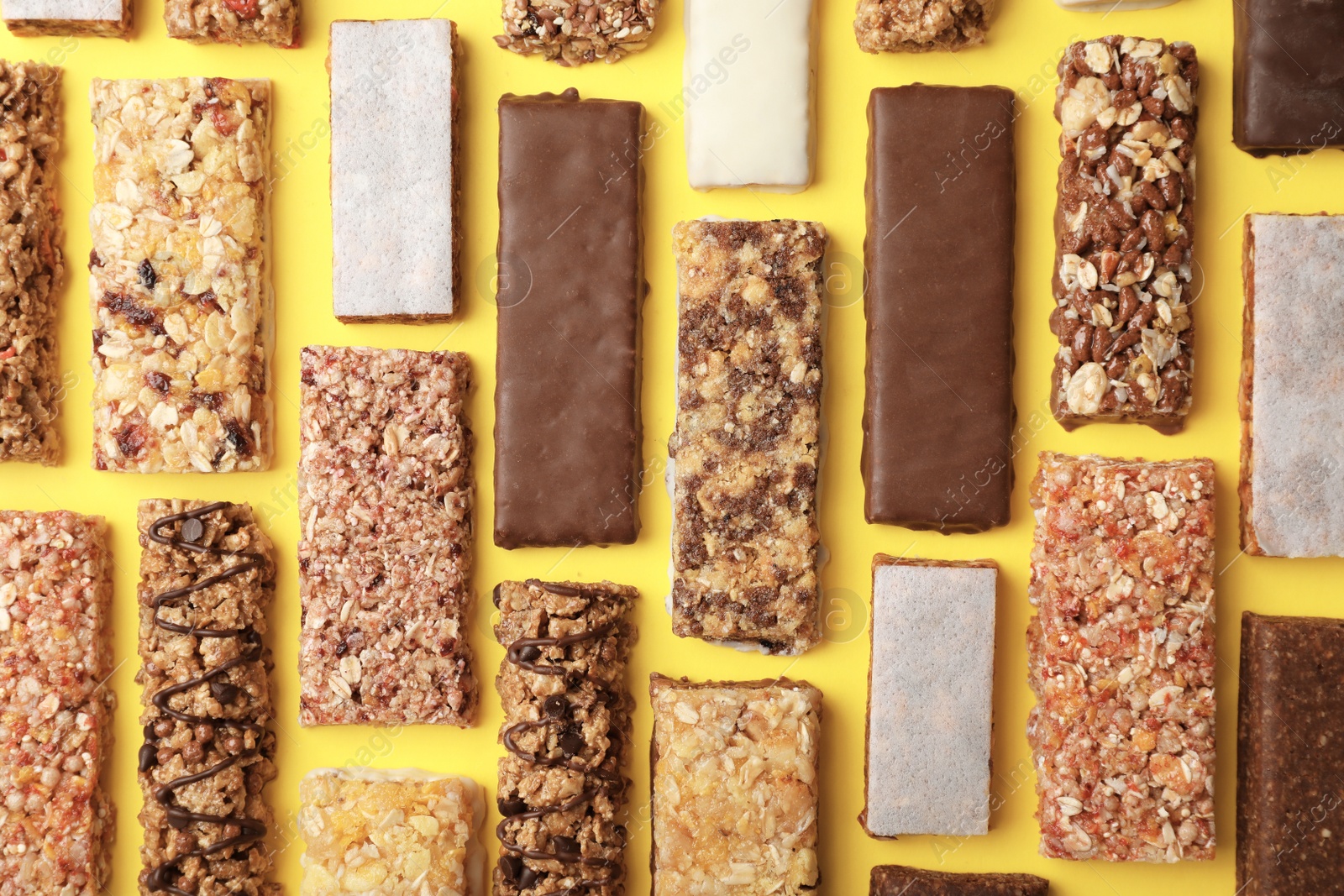 Photo of Flat lay composition with protein bars on color background