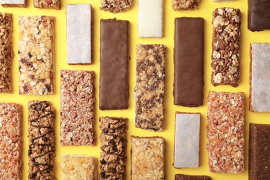 Photo of Flat lay composition with protein bars on color background