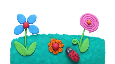 Photo of Flowers and ladybug made of plasticine on white background, top view