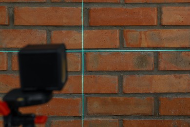 Photo of Cross lines of laser level on brick wall