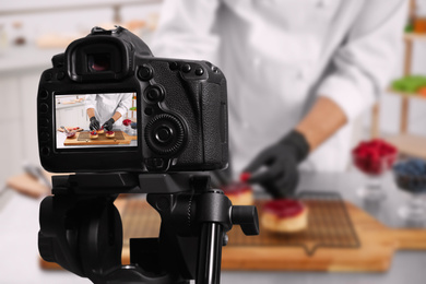 Image of Food photography. Shooting of chef decorating dessert, focus on camera