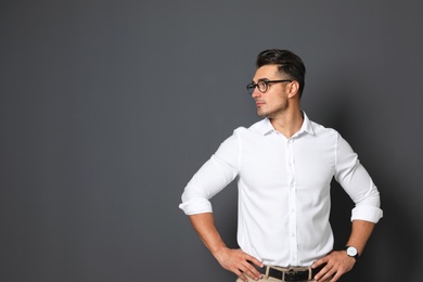 Portrait of handsome young man and space for text on black background