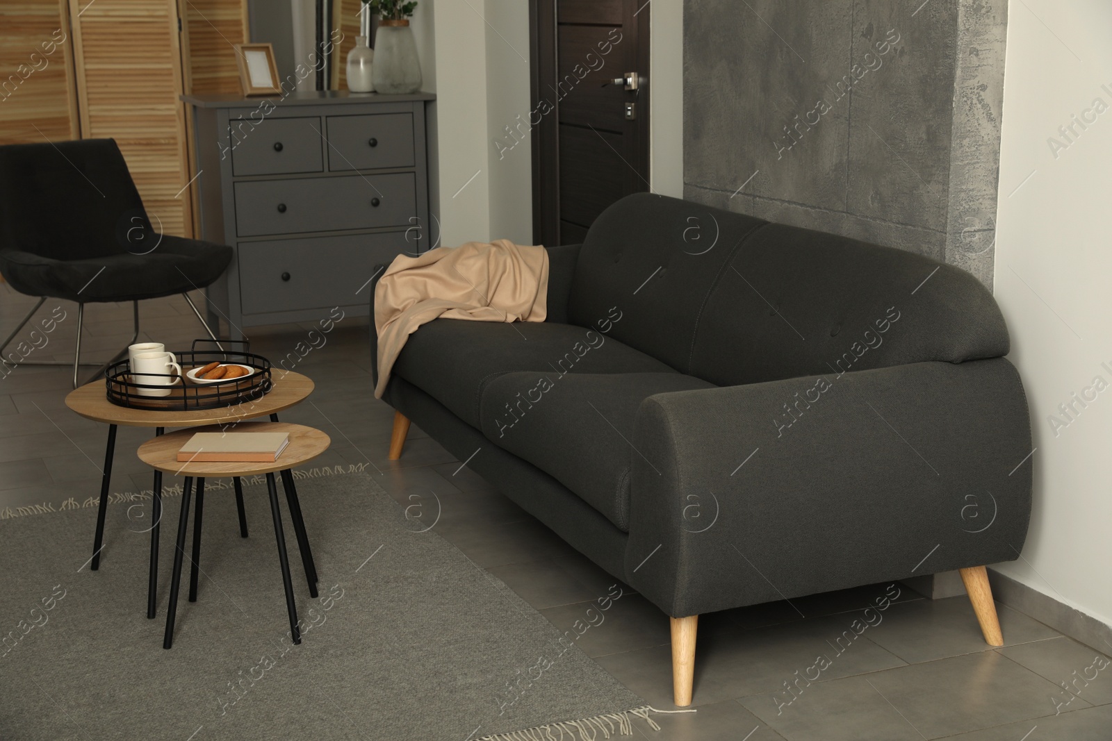 Photo of Stylish living room interior with comfortable grey sofa
