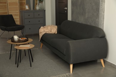 Photo of Stylish living room interior with comfortable grey sofa