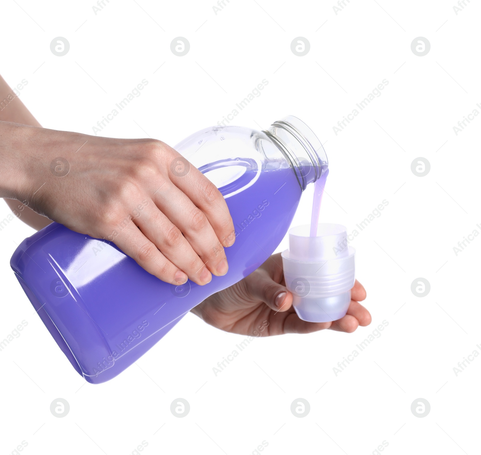 Photo of Woman pouring fabric softener from bottle into cap on white background, closeup