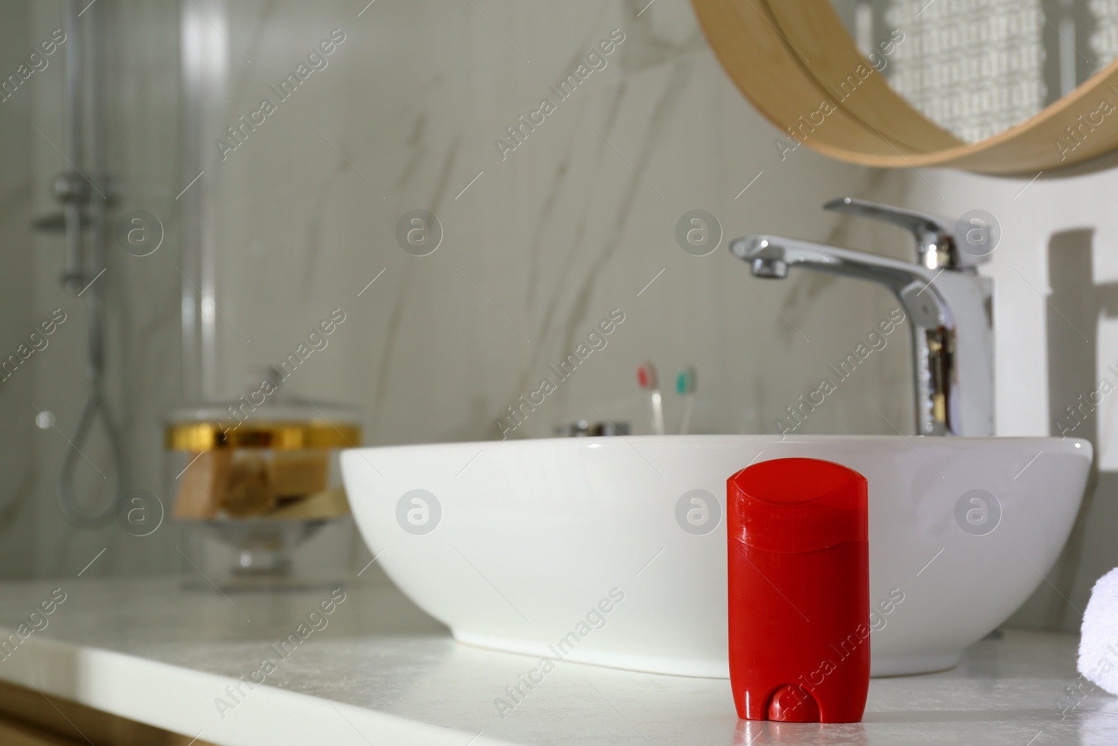 Photo of Deodorant container on light countertop in bathroom