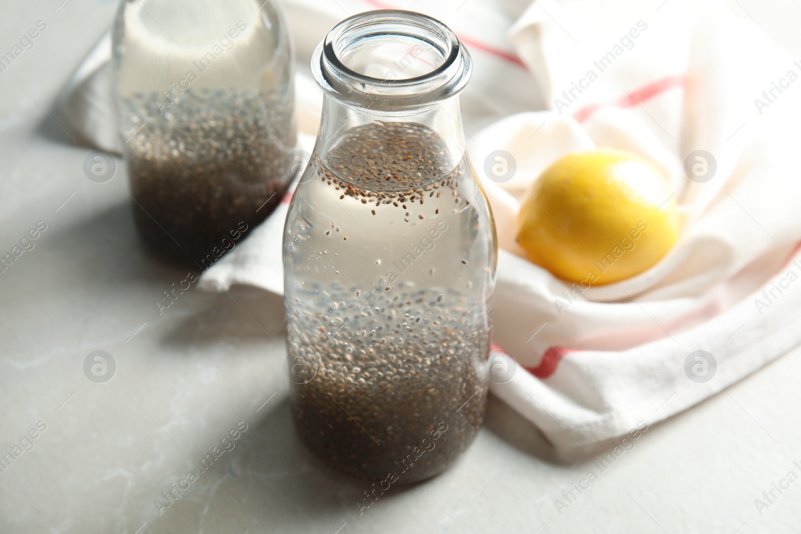 Photo of Composition with bottle of water and chia seeds on table