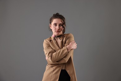 Photo of Portrait of beautiful young woman on grey background