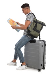 Man with suitcase and backpack reading map on white background. Summer travel