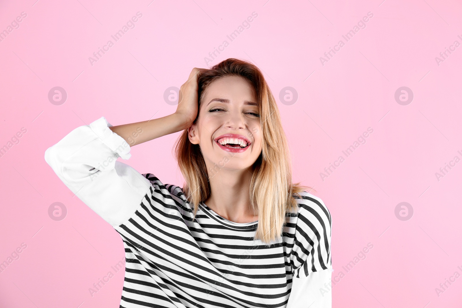 Photo of Portrait of beautiful laughing woman on color background