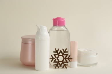 Beautiful composition with cosmetic products on beige background. Winter care