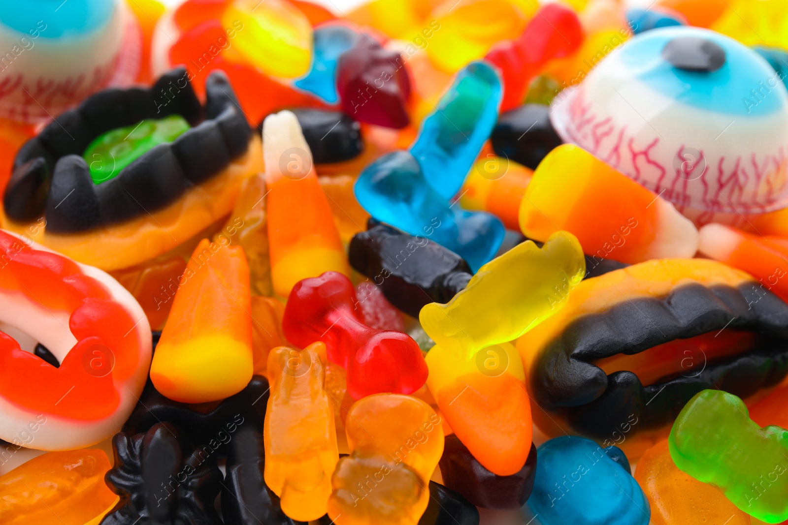 Photo of Delicious colorful candies as background, closeup. Halloween sweets