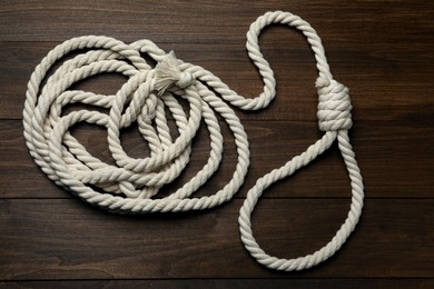 Photo of Rope noose on wooden table, top view