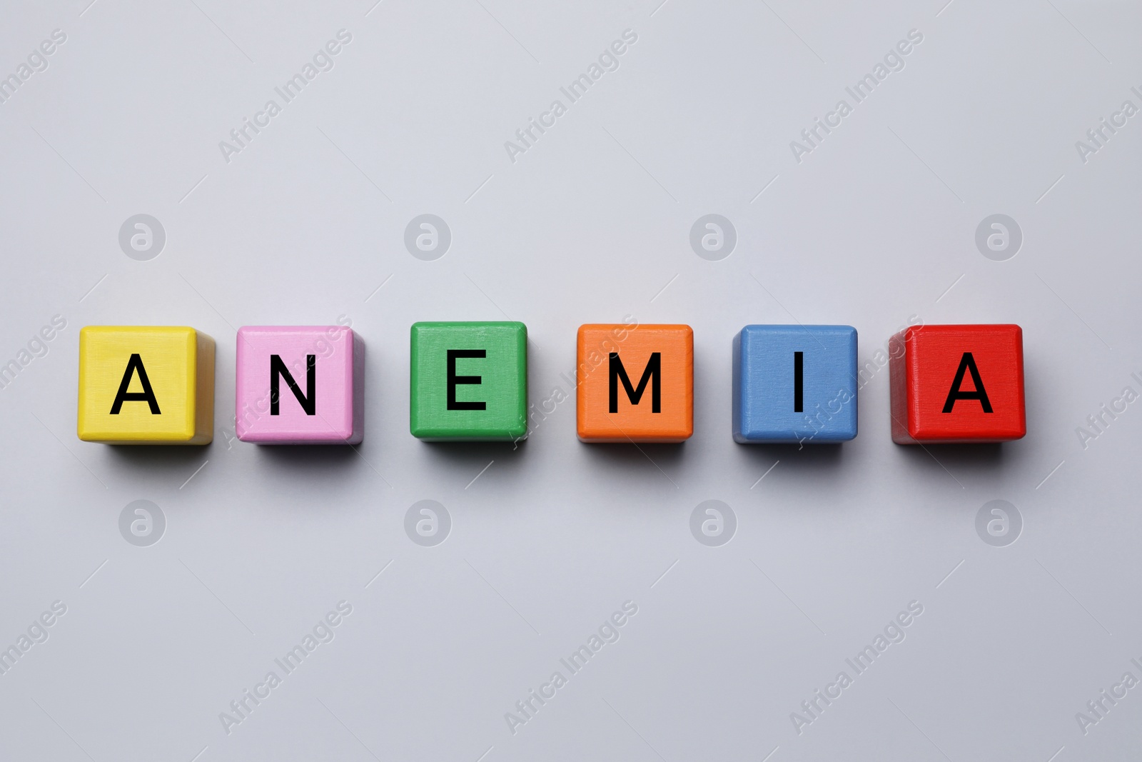 Photo of Blank colorful wooden cubes on grey background, flat lay. Space for text