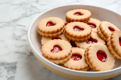 Traditional Christmas Linzer cookies with sweet jam on plate