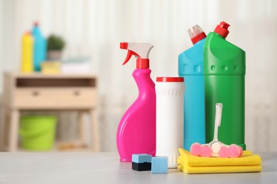 Photo of Different toilet cleaning supplies and tools on table indoors, space for text