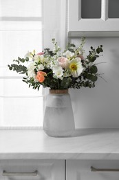 Photo of Bouquet of beautiful flowers on white countertop indoors