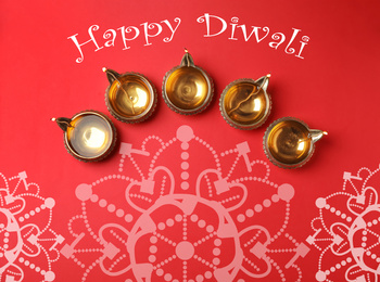 Image of Inscription Happy Diwali and clay lamps on color background, flat lay 