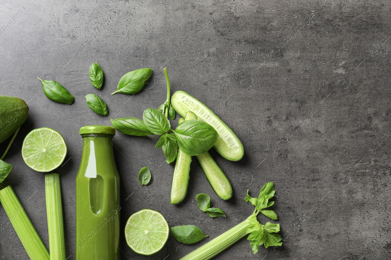 Photo of Flat lay composition with bottle of delicious detox juice and ingredients on grey background